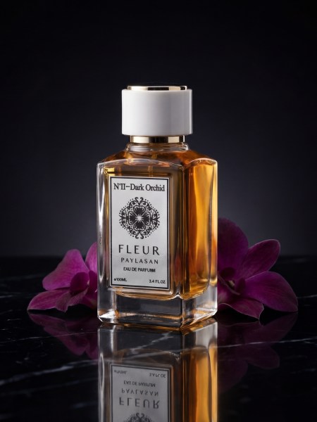 Dark Orchid perfume bottle on clean black marble background
